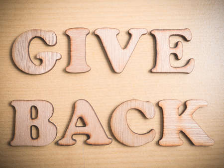 Give Back in wooden words letter, motivational self development business typography quotes concept