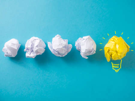 Idea bulb lamp made of paper over blue background, concept of problem and solutionの写真素材