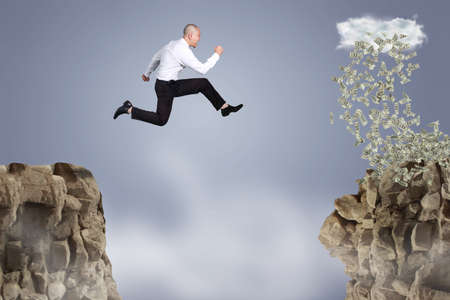 Businessman jumping off the mountain looking rain of money on the other side, risky job pursue...