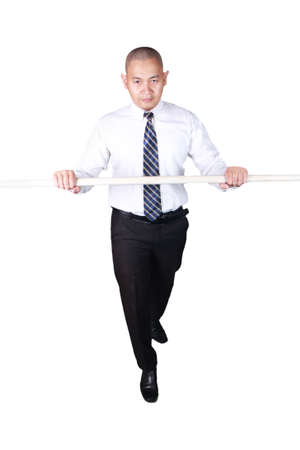 Young businessman wearing white suit and black pants rope walking gesture. Isolated on white. Full body portraitの写真素材