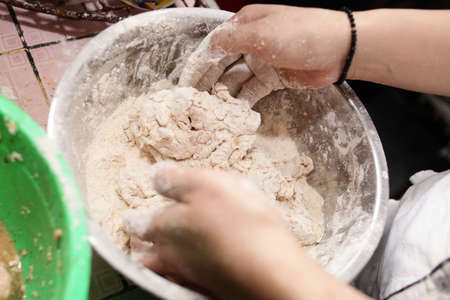 Close up image of cooking fried chicken preparation, flouring chicken before frying process