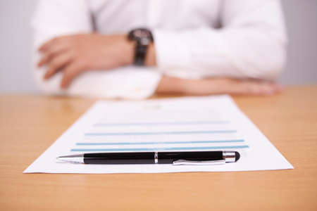 Close up image of businessman facing contract document or student finishing test exam, selective focus imageの写真素材