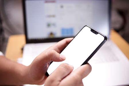 Close up image of smart phone mockup, businessman holding phone with white screen template