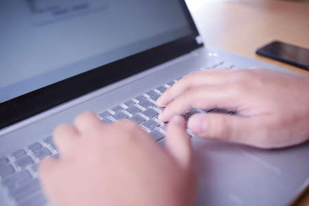 Close up image of businessman hands typing on notebook, copy writer, working on laptop computer
