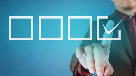 Businessman checking mark on checklist. Making a choice concept. Choosing on from many options