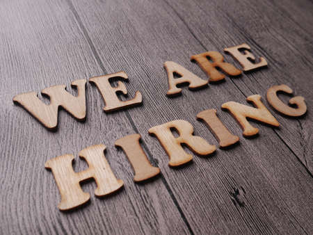 We Are Hiring, Motivational Business Recruitment Words Quotes Concept words letter, written on paper, work desk top view typographyの写真素材