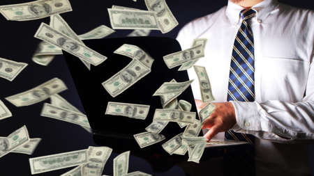 Businessman holding laptop and winning plenty of money in social media. Close up body portrait