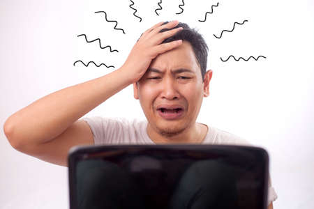 Portrait of Asian businessman tired sick stress shocked headache gesture because of bad news on...