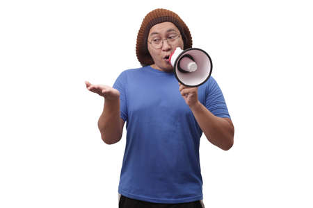 Young Asian man wearing casual blue shirt with megaphone, shouting and smiling. Close up body...