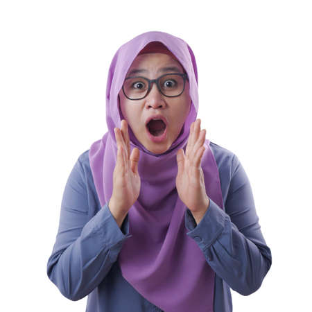 Portrait of cute young Asian muslim lady wearing hijab shows surprised or shocked expression with...