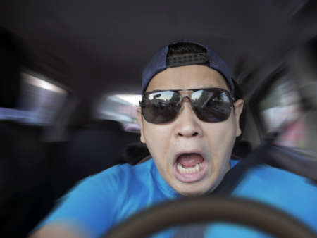 Portrait of male Asian driver shocked and panic about to have crash accident, zoomed motion blur defocus conceptの写真素材