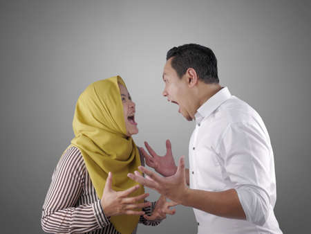 Portrait of Asian muslim couple husband and wife having fight, argue on each other, bad relationship...