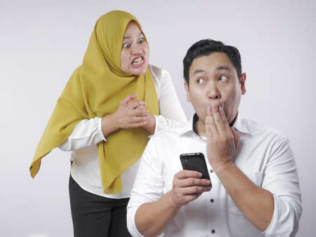 Muslim couple having fight, jealous wife finds her husband cheating on mobile phone. Couple conflict...
