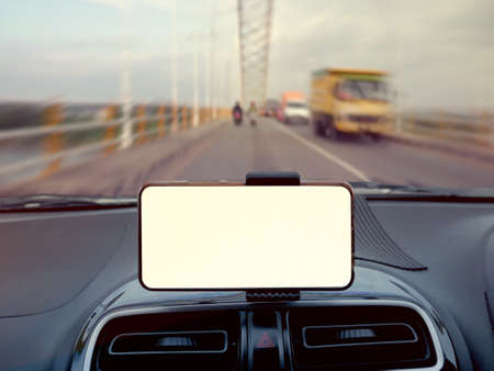 Close up image of smart phone on car mock up, riding a car with smartphone map navigation concept, blank phone screen templateの写真素材
