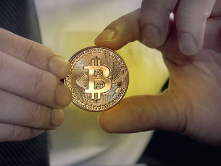 Businessman stacking physicalon his hand, investment in cryptocurrency concept