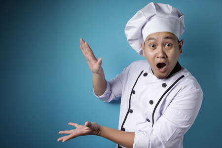 Portrait of Asian chef looked shocked surprised excited expression when looking to the side, against...