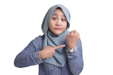Portrait of muslim businesswoman boss manager leader lady looked angry while showing her wrist...