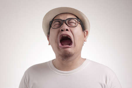 Photo image of funny Asian man crying hard, sad depression frustration hopeless expressionの写真素材