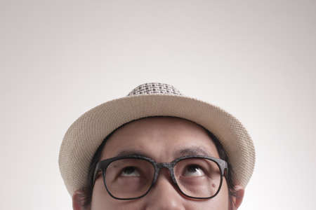 Photo image of young Asian man looked happy thinking and looking up, having good idea. Half body...