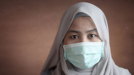 Muslim woman wearing mask to prevent coronavirus covid 19 pandemicの写真素材