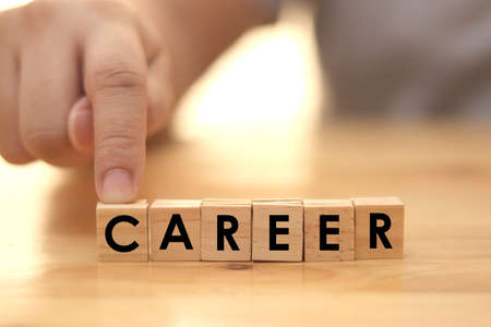 Career, man arrange word text typography written on wooden alphabet letterpress cubesの写真素材