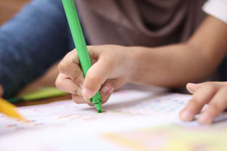 Close up young girl painting with colorful hands. Art, creativity and painting concept. の写真素材