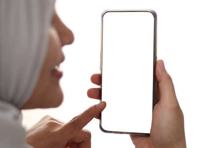 Close up image of smart phone mockup, muslim woman holding phone with white screen template