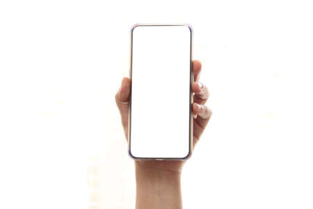 Close up of adult persons hand hold phone isolated on white, mock-up smartphone white color blank...