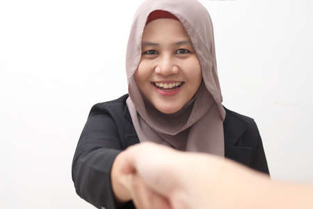 Successful negotiate and handshake concept, Asian muslim businesswoman shake hand with partner to...