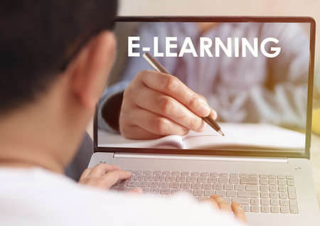 Anonymous person typing on laptop with e learning digital web program displayed on screen. Online education, e-learning conceptの写真素材