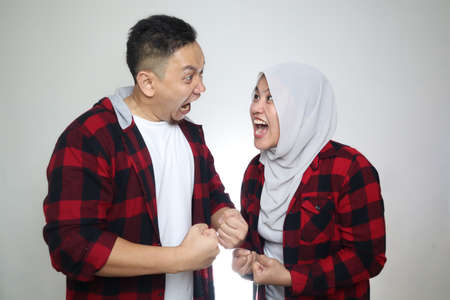 Portrait of Asian muslim couple husband and wife having fight, argue on each other, bad relationship in marriage conceptの写真素材