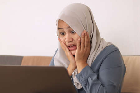 Shocked stressed young woman looking at laptop screen feeling bad after having crash error, sad girl...