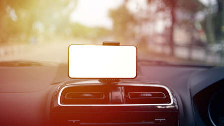 Close up image of smart phone on car mock up, riding a car with smartphone map navigation concept, blank phone screen templateの写真素材