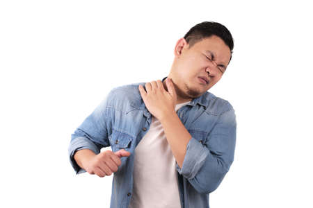 Young Asian man suffers from neck pain. Close up body portraitの写真素材