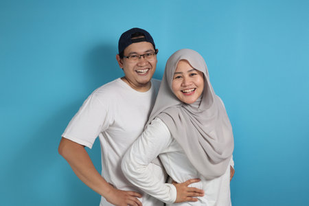 Portrait of happy Asian muslim couple smiling, husband and wife hugging full of love, family conceptの写真素材