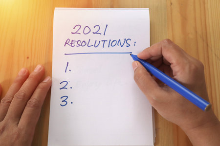 2021 resolutions, goals plans in life, business, close up of man writing and preparing for new year 2021の写真素材