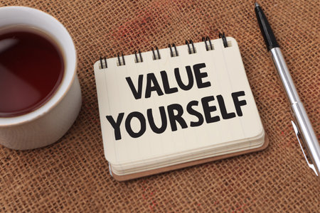 Value yourself, motivational inspirational words quotes text typography witten on book against wooden background, business conceptの写真素材