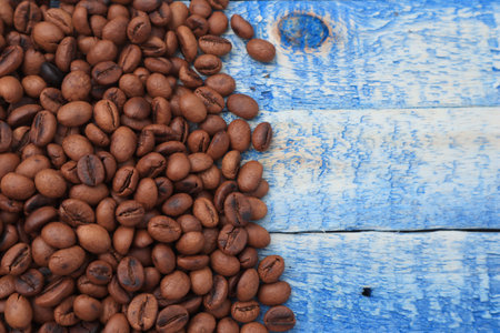 Roasted coffee beans background, on blue wooden board with copy spaceの写真素材