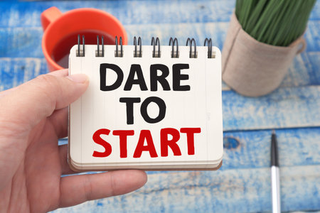 Dare to Start, motivational inspirational words quotes text typography witten on book against wooden background, business and self development conceptの写真素材