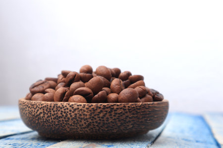Roasted coffee beans in a wooden bowl with copy spaceの写真素材