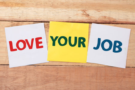 Love your job, text words typography written on color paper against wooden background, life and business motivational inspirational conceptの写真素材