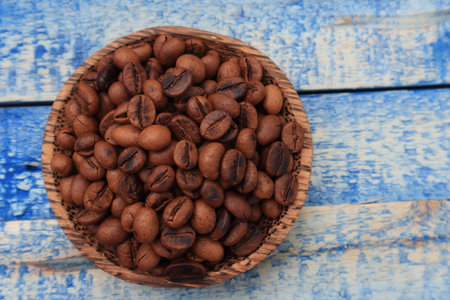 Roasted coffee beans in a wooden bowl with copy spaceの写真素材