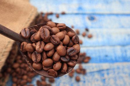 Roasted coffee beans background, on blue wooden board with copy spaceの写真素材