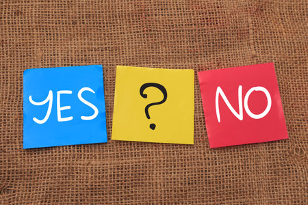Yes or No with question mark, text words typography written on color papers, choice decision doubt conceptの写真素材