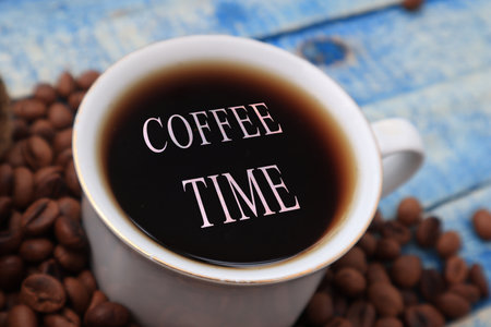 Coffee time text concept with cup of coffee on the table, top viewの写真素材
