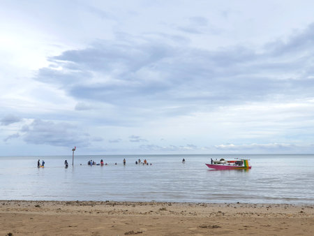 January 2021, Balikpapan Indonesia, lamaru beach, people enjoys calm ocean waves, travel tourism destination conceptの写真素材