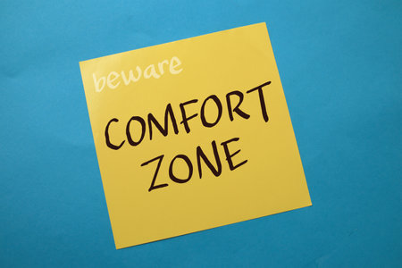 Comfort zone, text words typography written on paper against blue background, life and business...