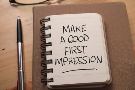 Make a good first impression, text words typography written on book against wooden background, life...