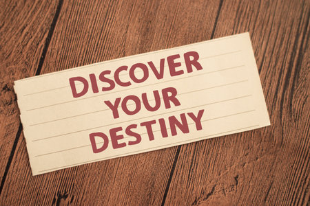 Discover your destiny, text words typography written on paper against wooden background, life and...