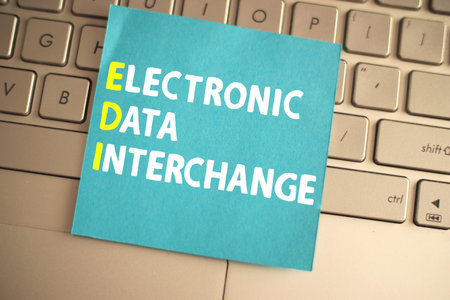 Electronic data interchange, text words typography written on paper against computer keyboard, life and business motivational inspirational conceptの写真素材